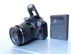 canon 100D DSLR body with lens