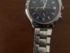 clean silver watch with a navy blue inside