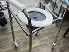 Commode chair with wheel