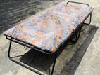 Folding bed with mattress