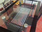 Glass table with four chairs