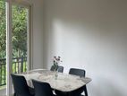 granite dining table with cushion chairs