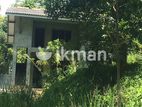 Land with Partly Constructed Building for Sale in Huluganga