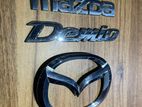 Mazda Demio DE3FS Badge