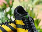 adidas sprintstars black with yellow spikes shoe