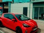 Rent Chilli Red Toyota Aqua Hybrid - starting from 7days