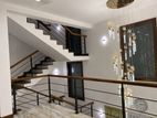 Staircase steel railings with teak handrails