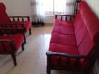 Teak Wooden 4+1+1 Seater Sofa Set with Red Fabric Cushions.
