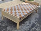Wooden bed with mattress