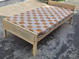 Wooden bed with mattress